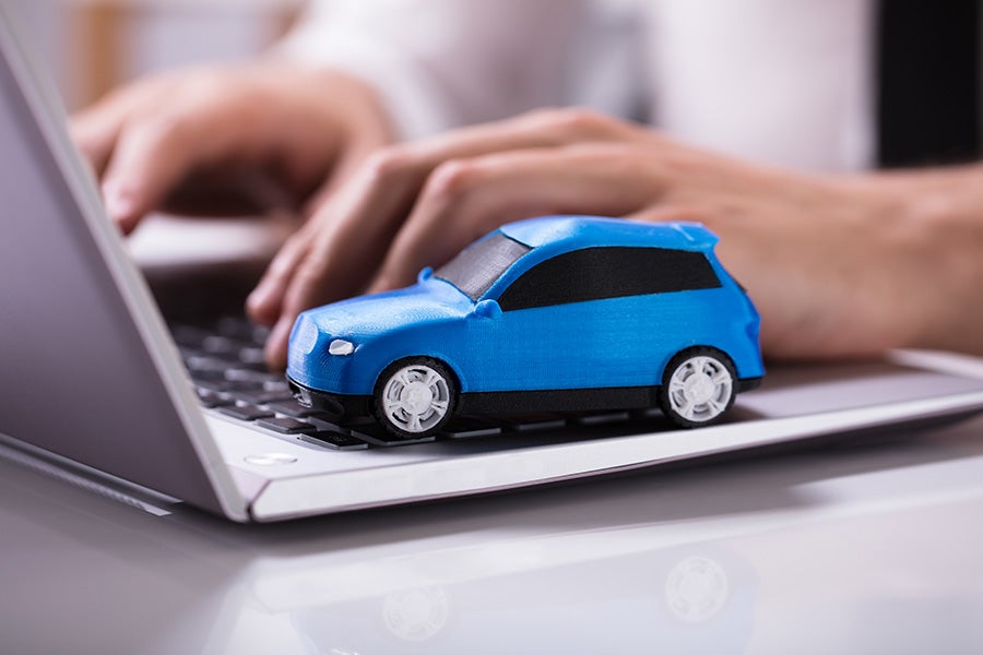 Car model placed on a laptop pad