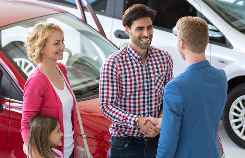 Dealer shaking hands with a family